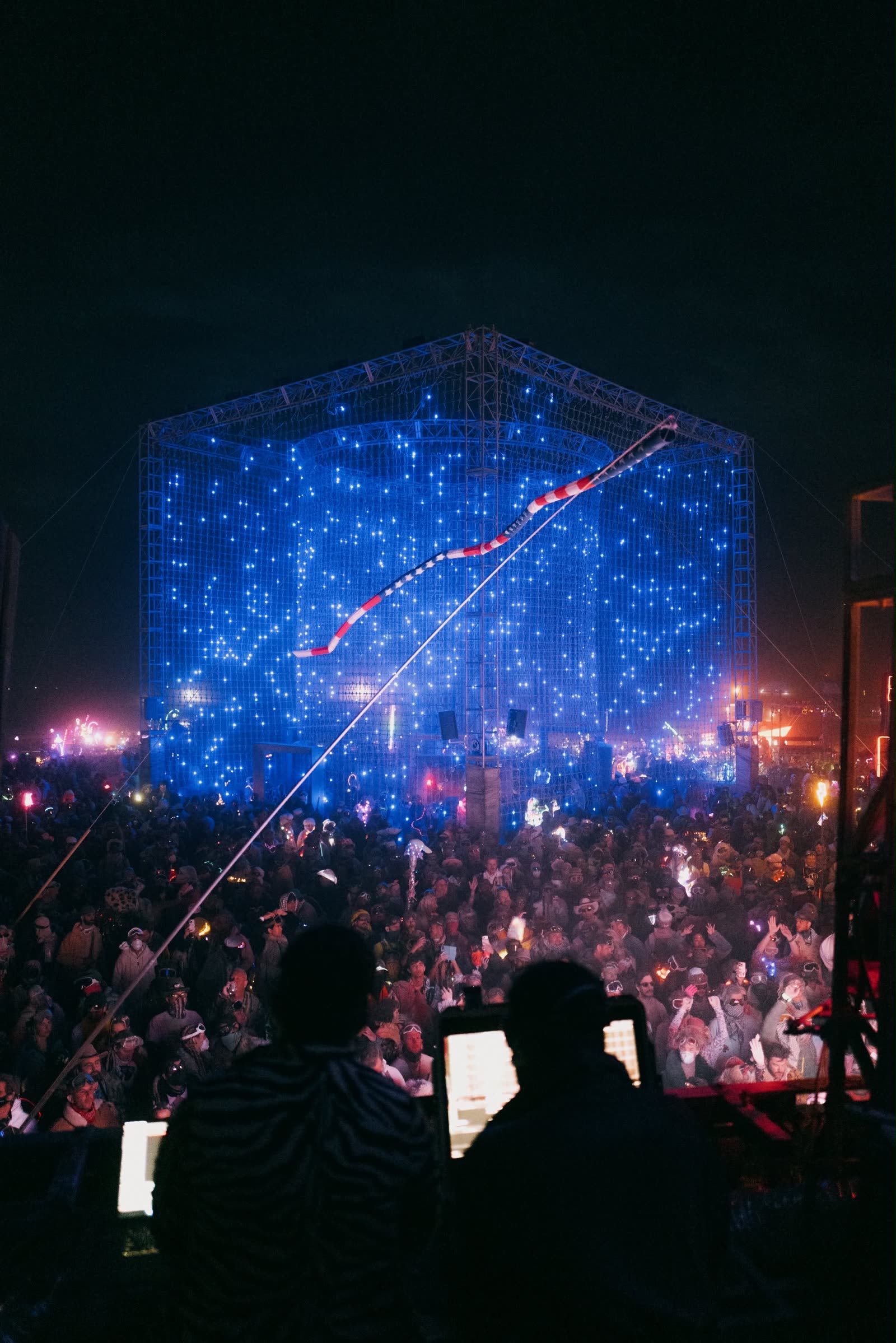 Inside the cube, everything blue, the crowd holding up phones
